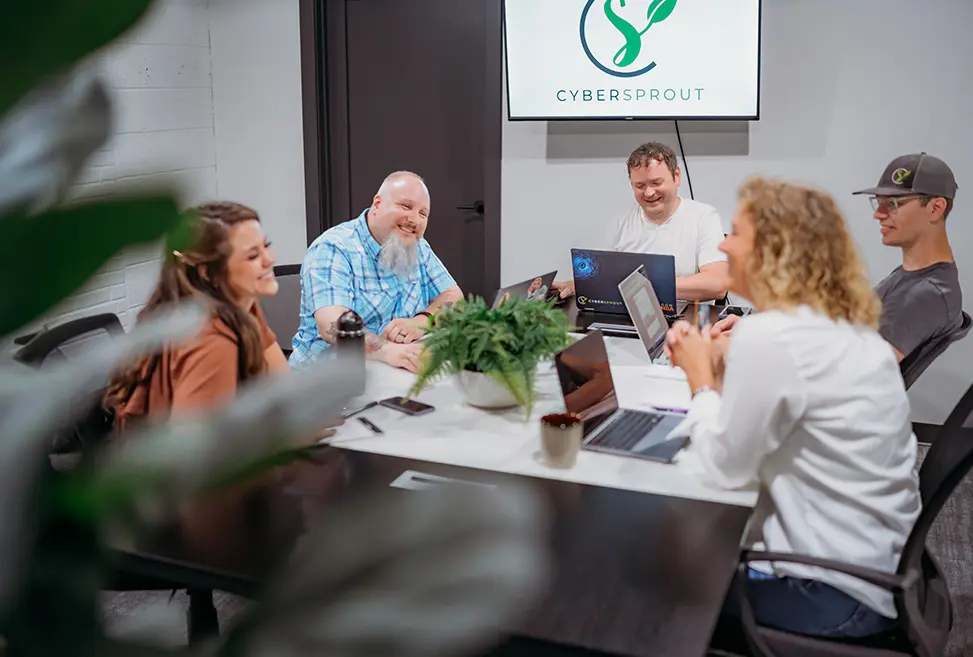 The CYBERsprout team working together around a table.