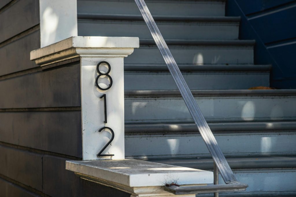 address posted on a house depicting the domain part of the domain and hosting combination