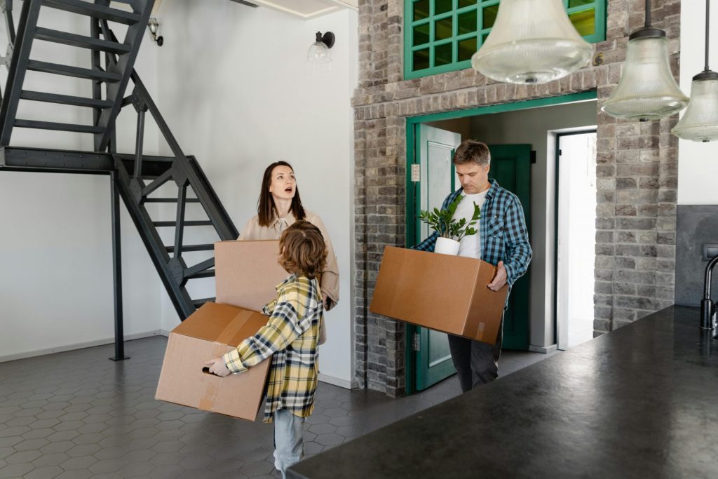 people moving storage boxes into home depicting the hosting portion of domain and hosting relationship